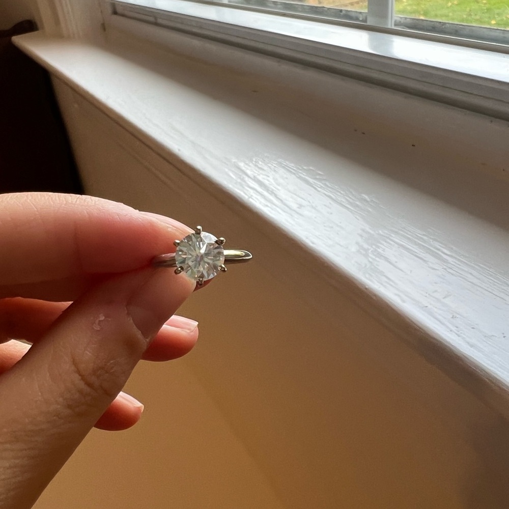 7.5mm Moissanite solitaire on a 14k white gold band size 5.25